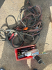 Assortment of air tools and booster cables