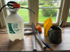 Weed sprayer jugs and pruning shears clothes line cable