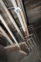 large variety of forks, rakes, & hose