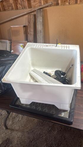 Laundry sink with plumbing fixtures