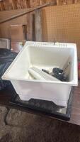 Laundry sink with plumbing fixtures