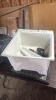 Laundry sink with plumbing fixtures