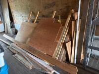 Assorted sheets of plywood and lumber