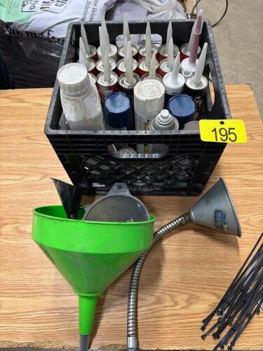 Assortment of caulking, paint and funnels