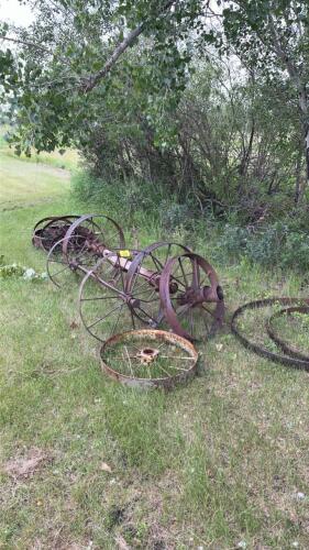 Assortment of antique axles and steel wheels
