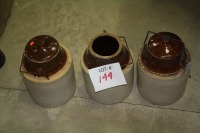 3- stoneware jugs - 2 w/lids (1 cracked)
